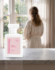 hideaway. Petal Dreams perfume 50ml bottle on a marble ledge by a sunlit window