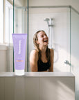 hideaway. Mini Black Essence Body Wash on a shower ledge in a bright bathroom