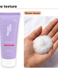 Shower mousse texture in an open palm, beside Hideaway. Aurora Rouge shower mousse