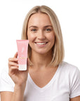 A smiling woman holding Hideaway. Vanilla Delight mini body custard