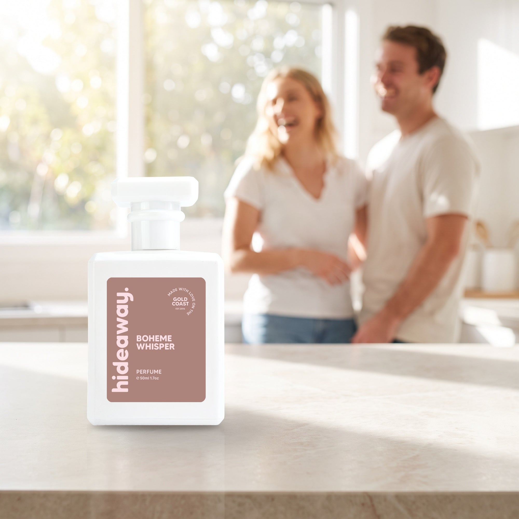 hideaway. Boheme Whisper perfume 50ml bottle on a stone benchtop in a bright kitchen