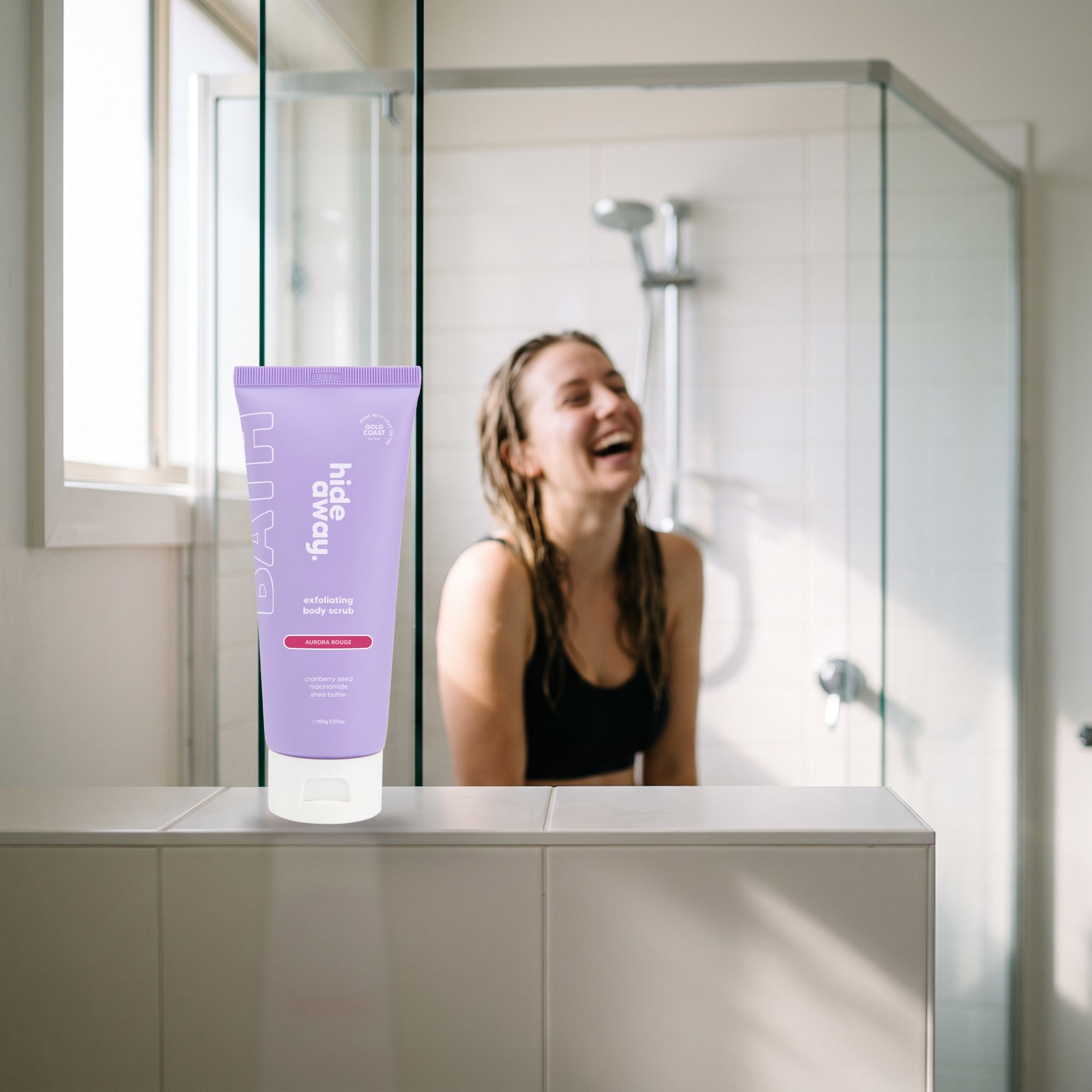 hideaway. Aurora Rouge Body Scrub on a shower ledge in a bright bathroom