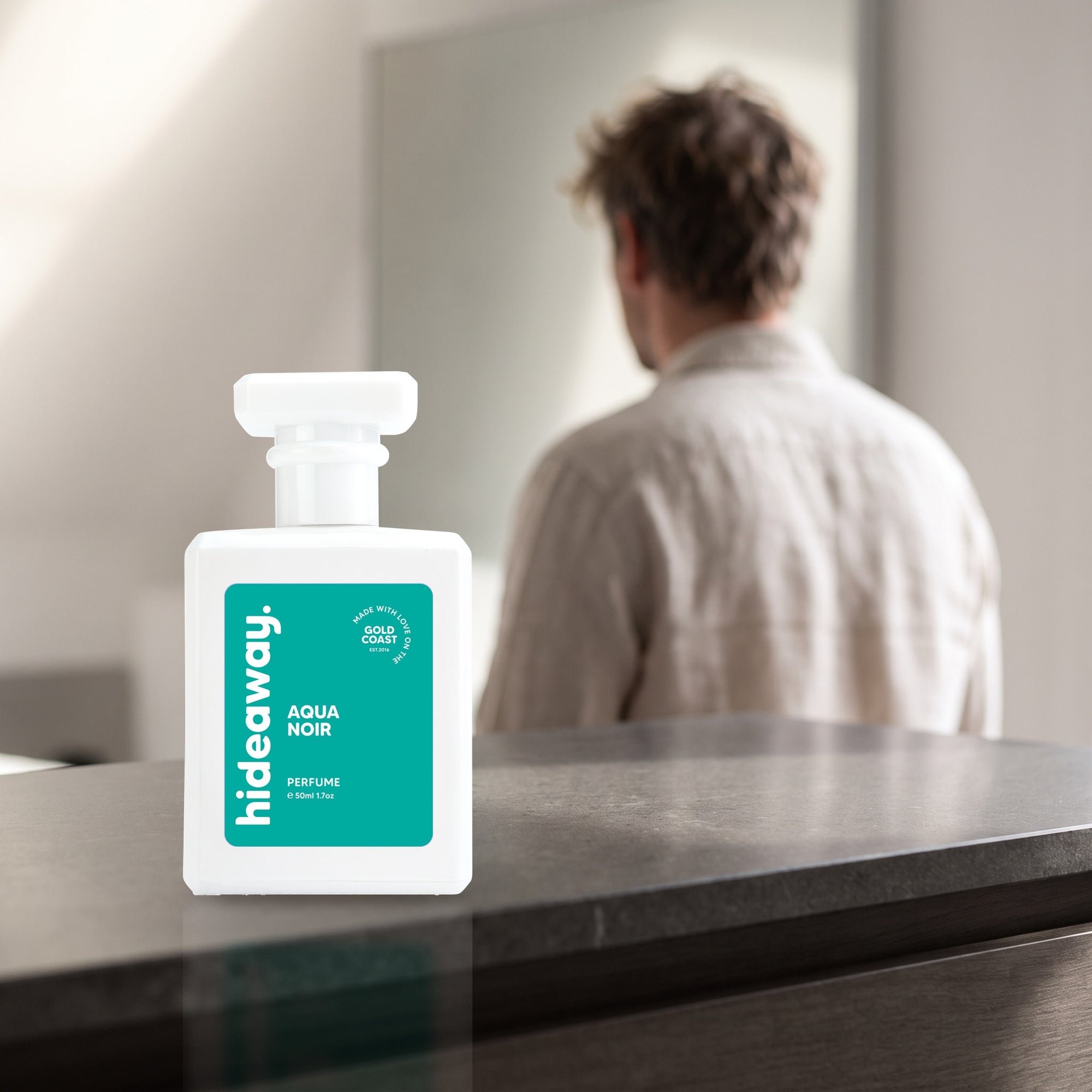 hideaway. Aqua Noir perfume 50ml bottle on a stone dresser in soft morning light