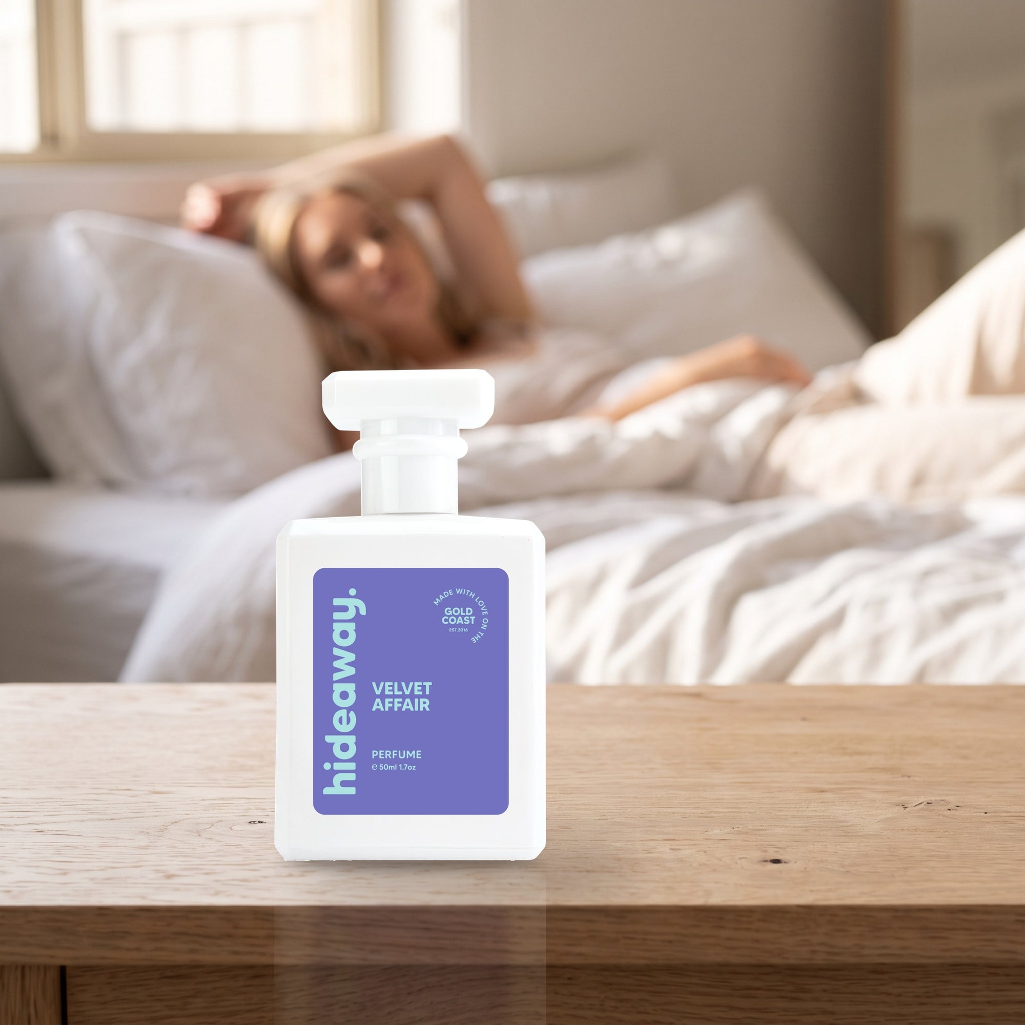 hideaway. Velvet Affair perfume 50ml bottle on a bedside table in warm morning light