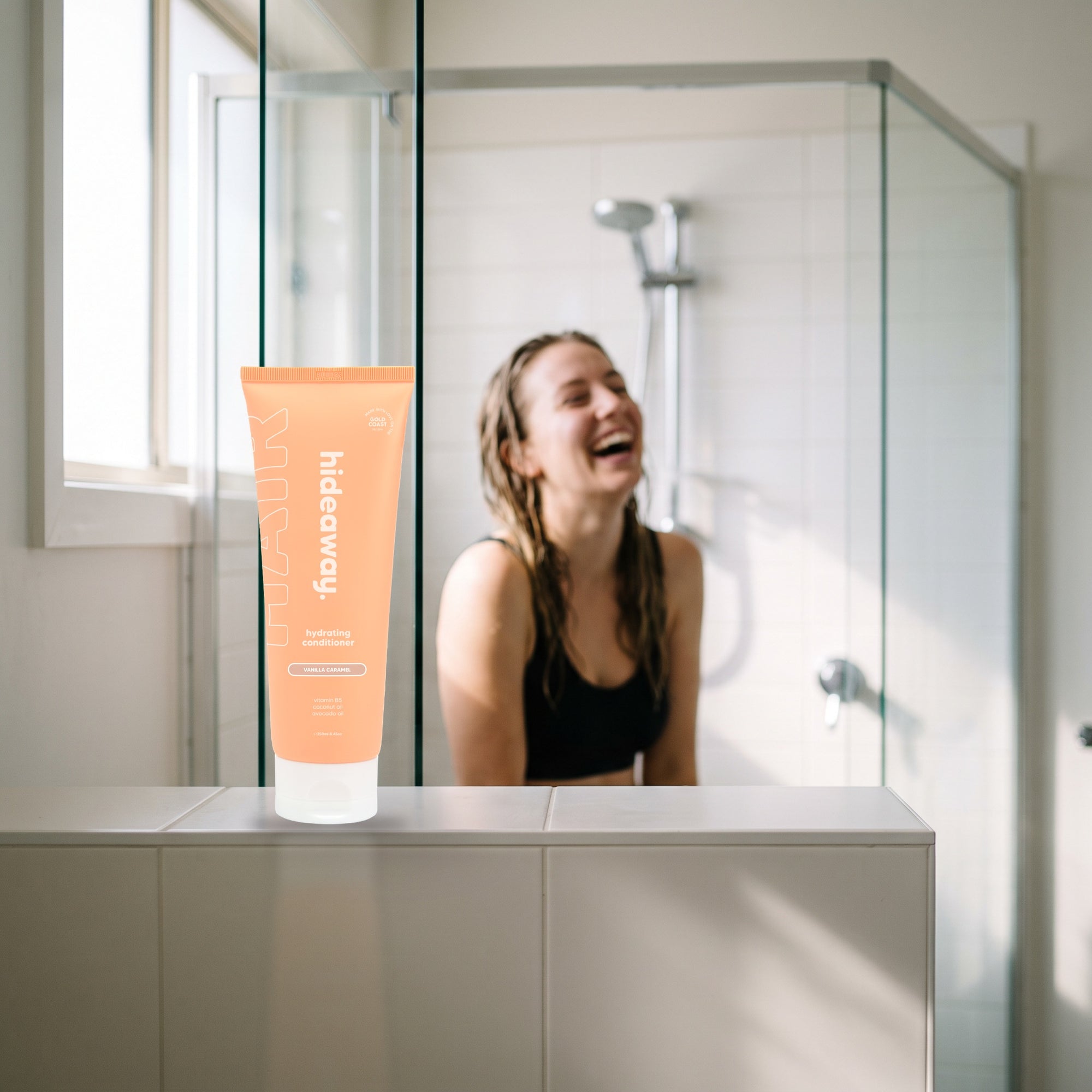 hideaway. Vanilla Caramel Conditioner on a shower ledge in a bright bathroom