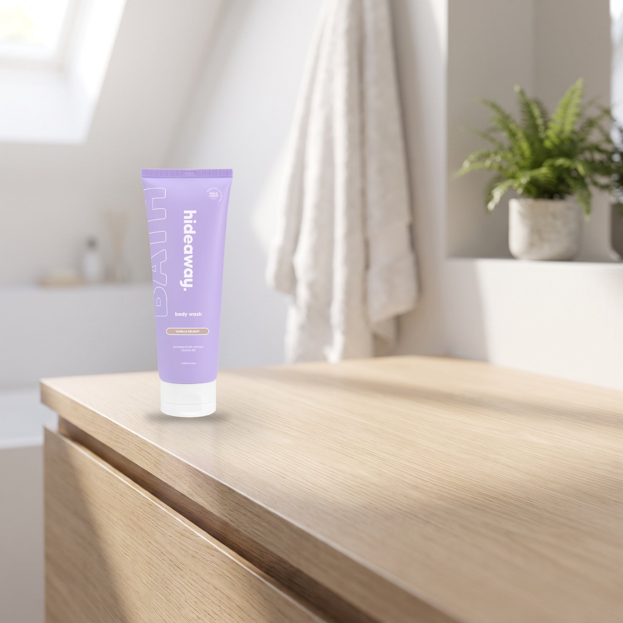 hideaway. Vanilla Delight Body Wash on a pale timber vanity top in a bright bathroom