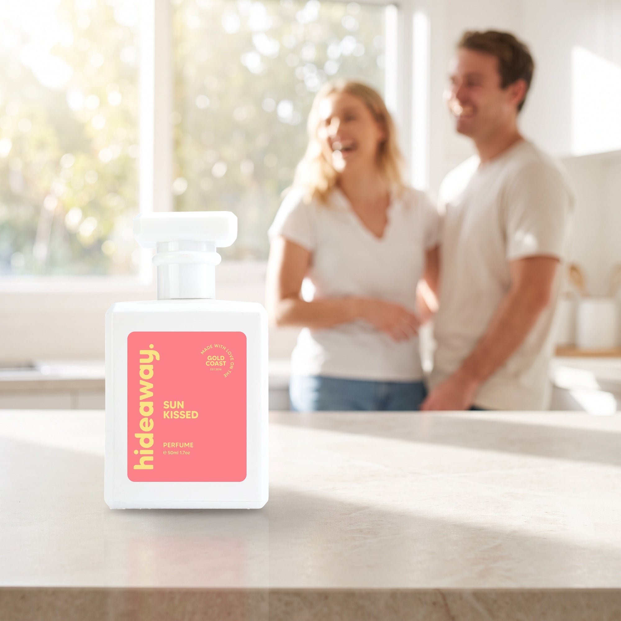 hideaway. Sun Kissed perfume 50ml bottle on a stone benchtop in a bright kitchen