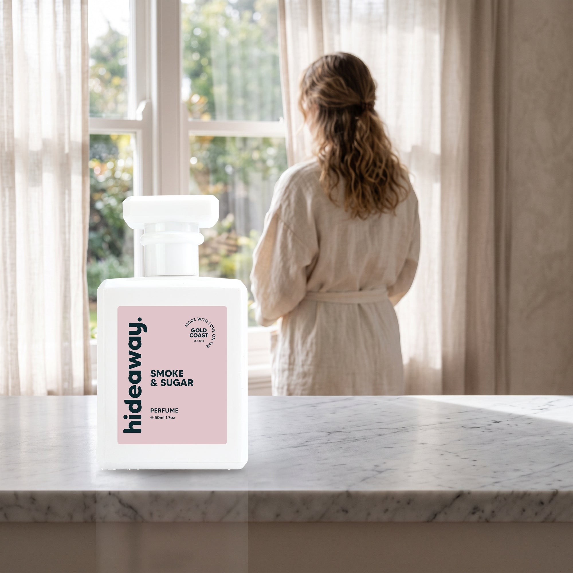 hideaway. Smoke & Sugar perfume 50ml bottle on a marble ledge by a sunlit window