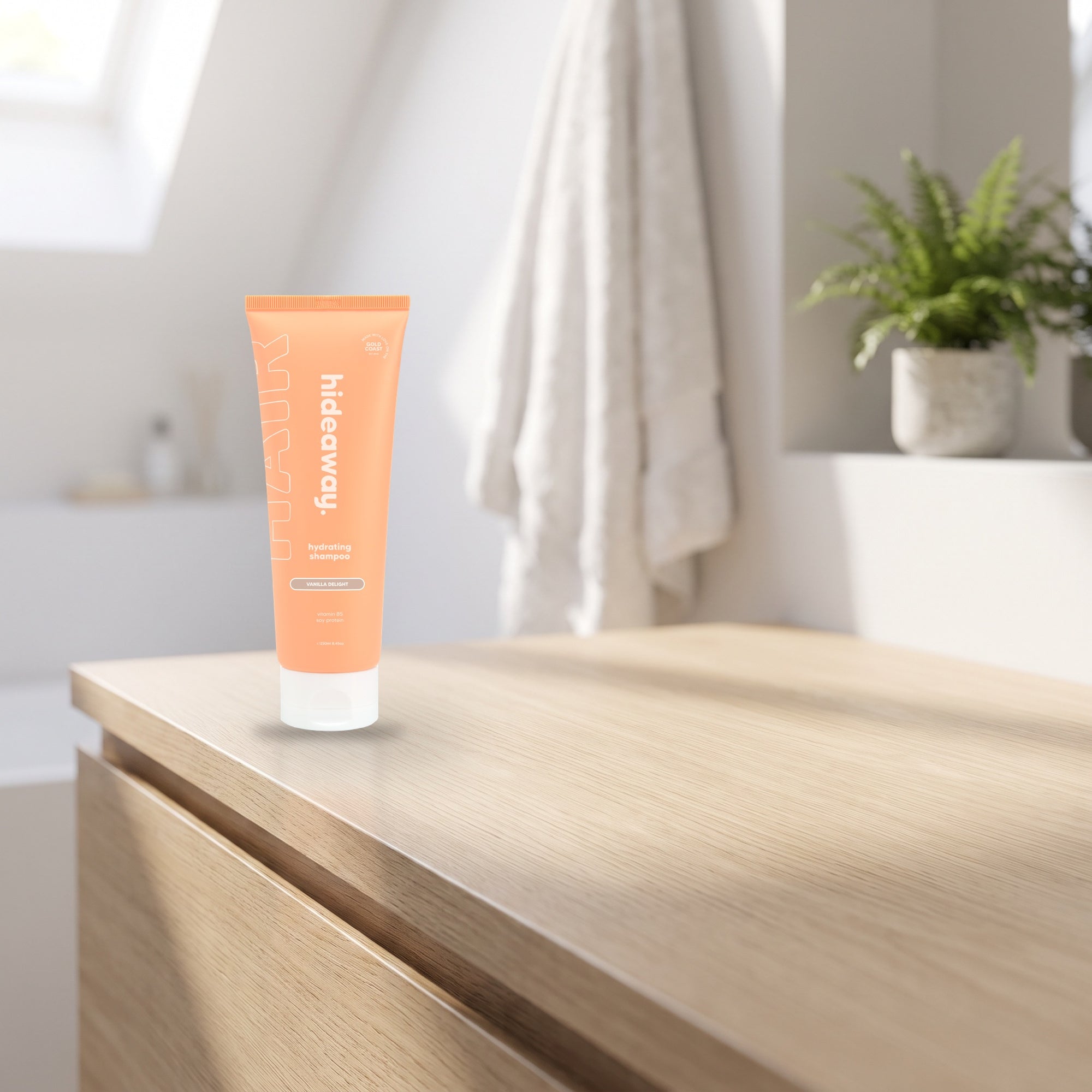 hideaway. Vanilla Delight Shampoo on a pale timber vanity top in a bright bathroom