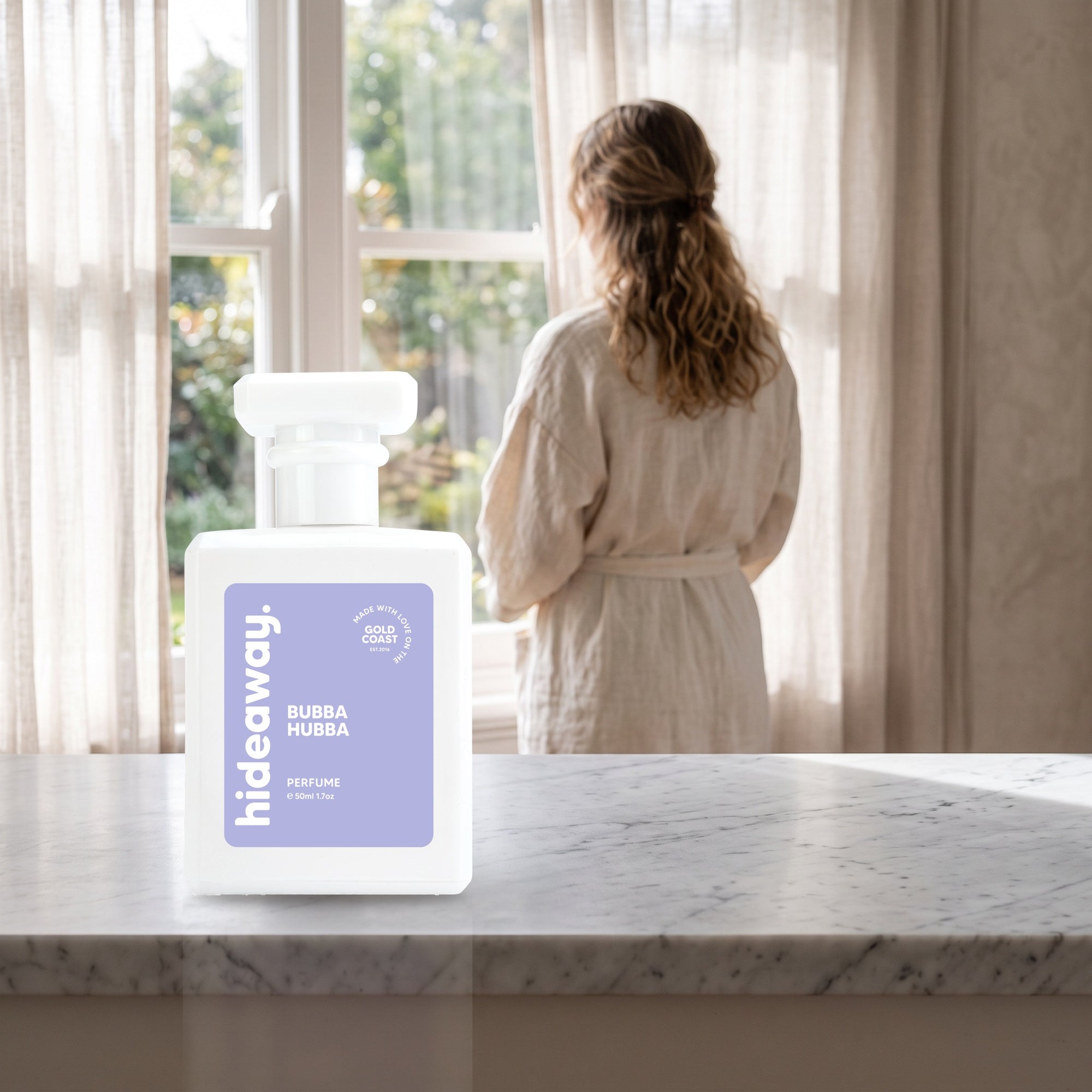 hideaway. Bubba Hubba perfume 50ml bottle on a marble ledge by a sunlit window
