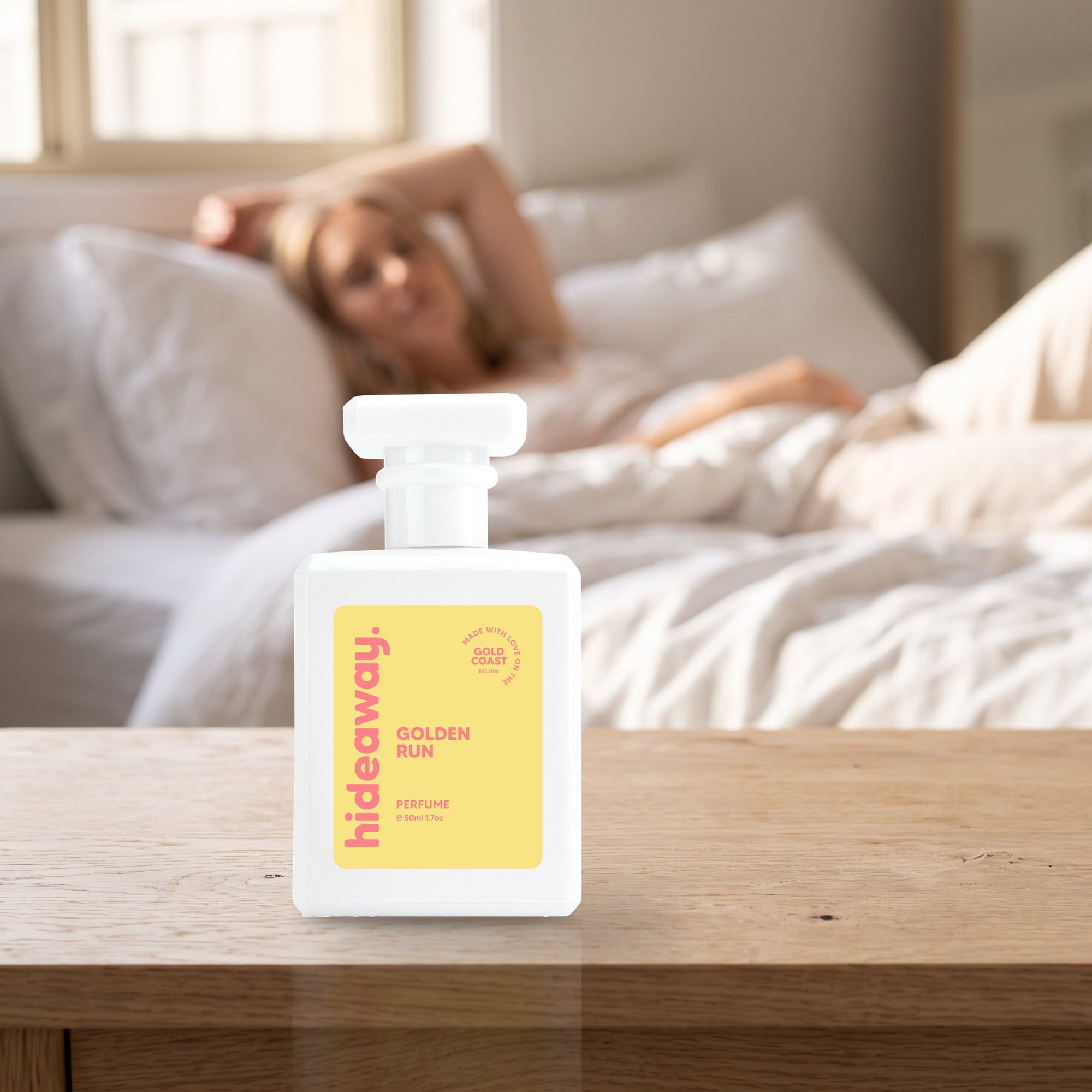 hideaway. Golden Run perfume 50ml bottle on a bedside table in warm morning light