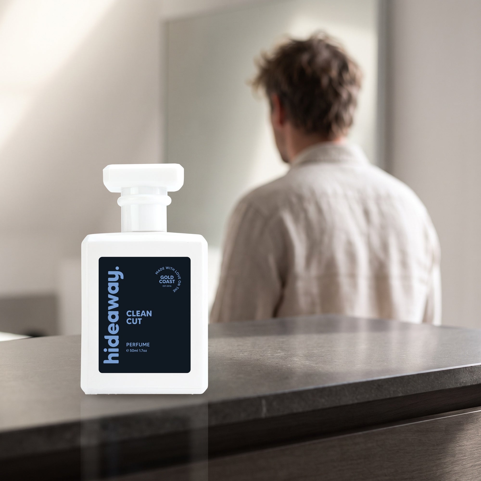 hideaway. Clean Cut perfume 50ml bottle on a stone dresser in soft morning light