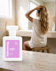 hideaway. Elegant Charm perfume 50ml bottle on a travertine vanity while she gets ready in the morning