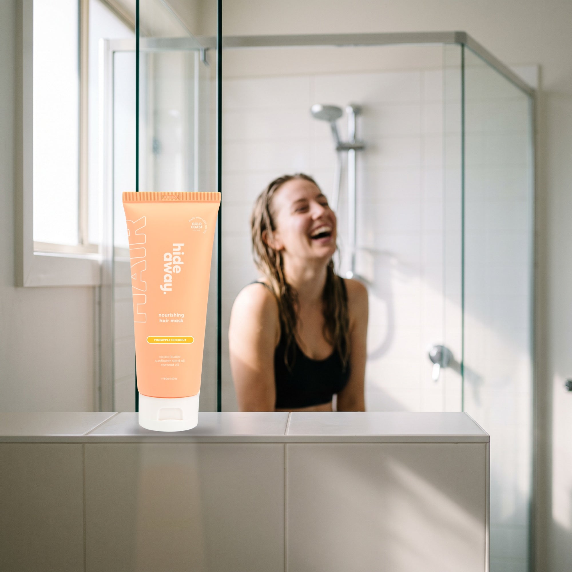 hideaway. Pineapple Coconut Hair Mask on a shower ledge in a bright bathroom