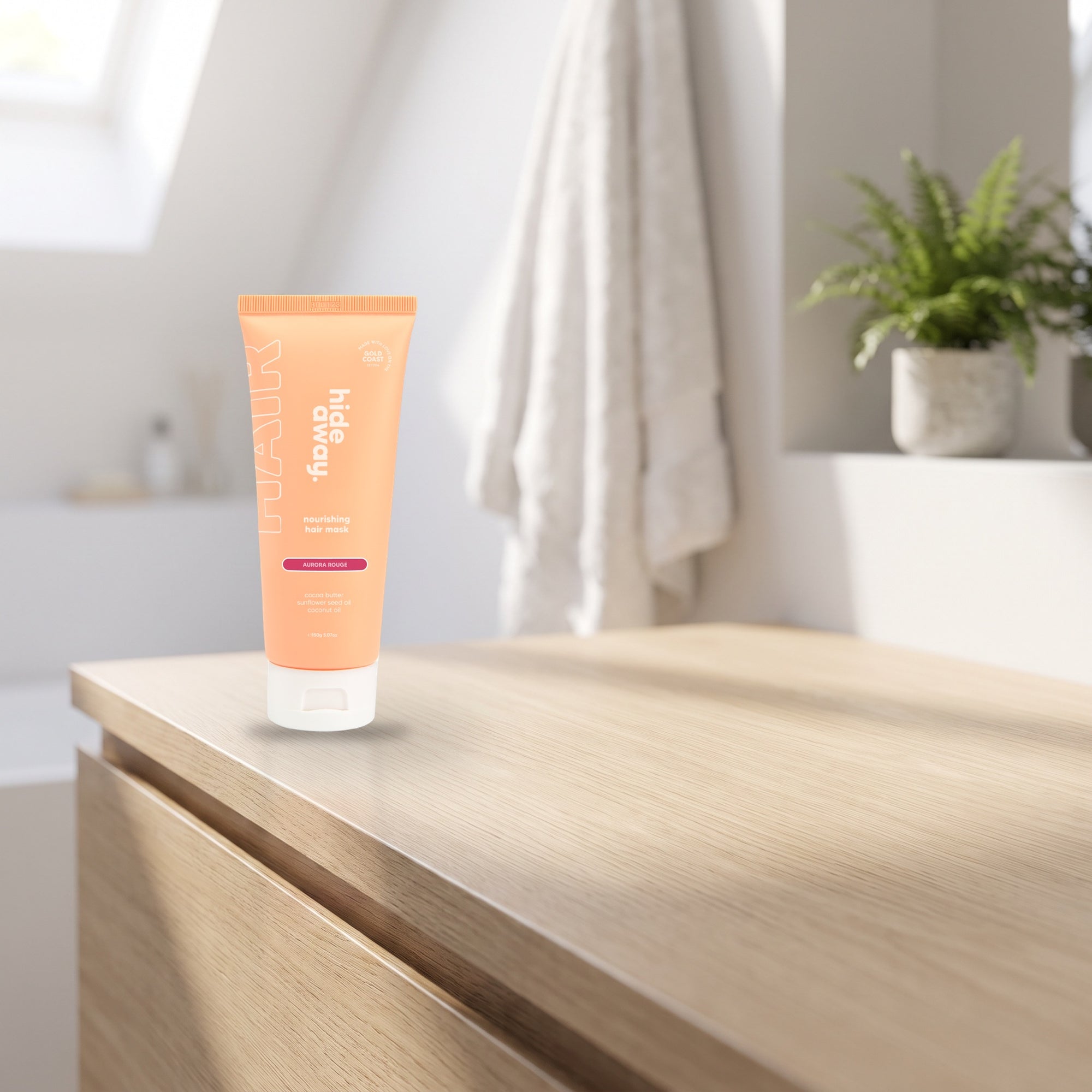 hideaway. Aurora Rouge Hair Mask on a pale timber vanity top in a bright bathroom