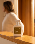 hideaway. Addictive Angel perfume 50ml bottle on a timber sill in warm afternoon light
