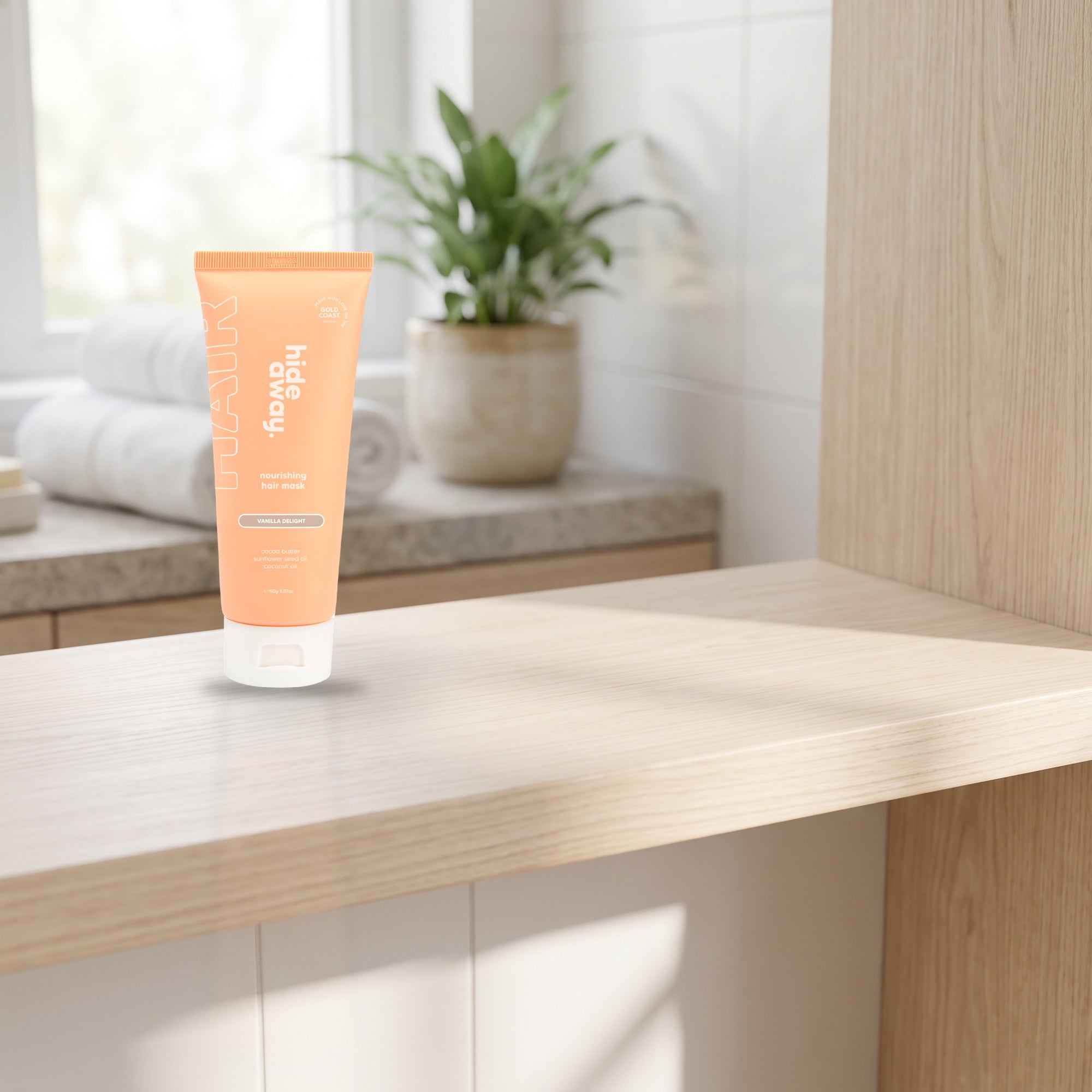 hideaway. Vanilla Delight Hair Mask on a timber bathroom shelf beside rolled towels