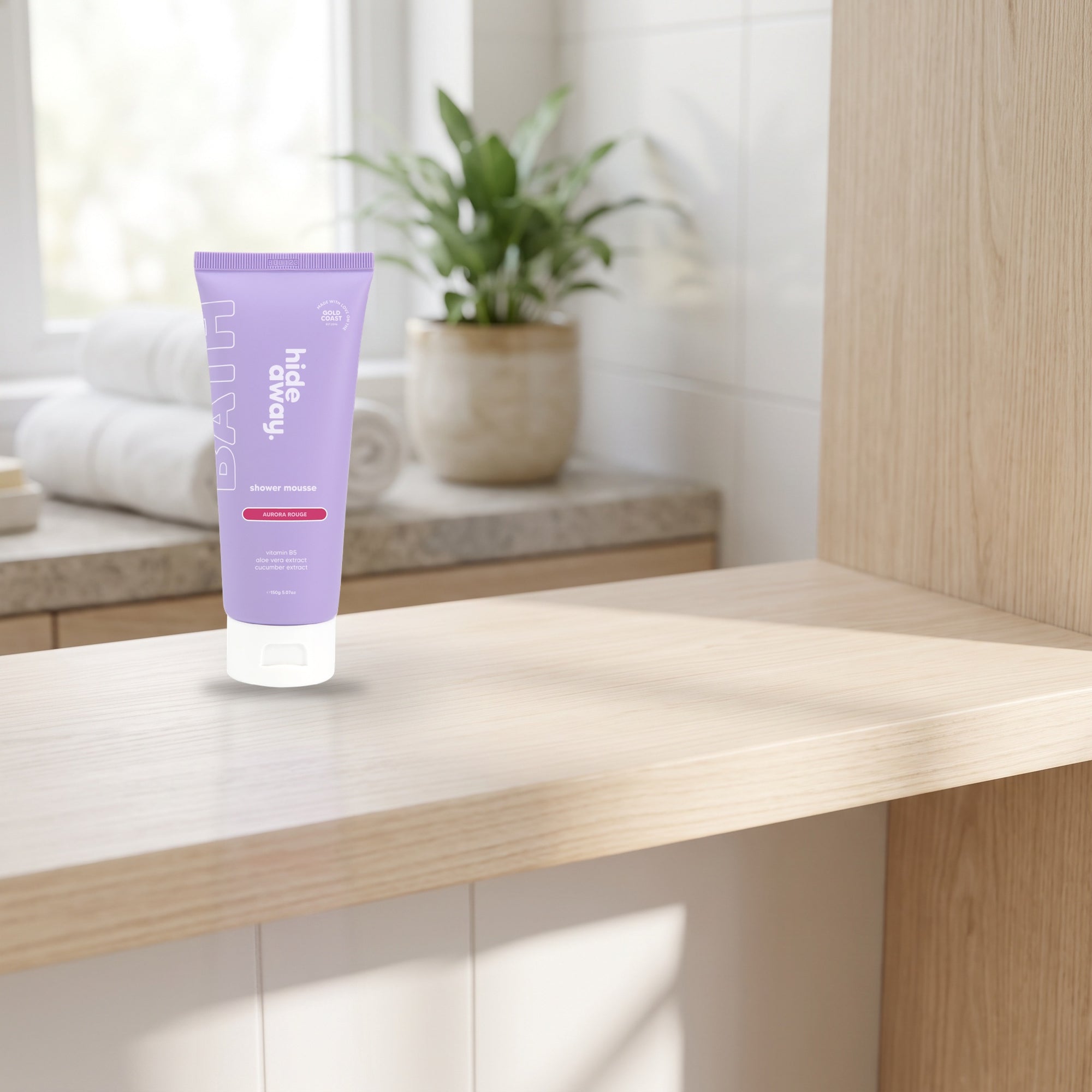 hideaway. Aurora Rouge Shower Mousse on a pale timber vanity top in a bright bathroom