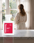 hideaway. Midnight Muse perfume 50ml bottle on a marble ledge by a sunlit window