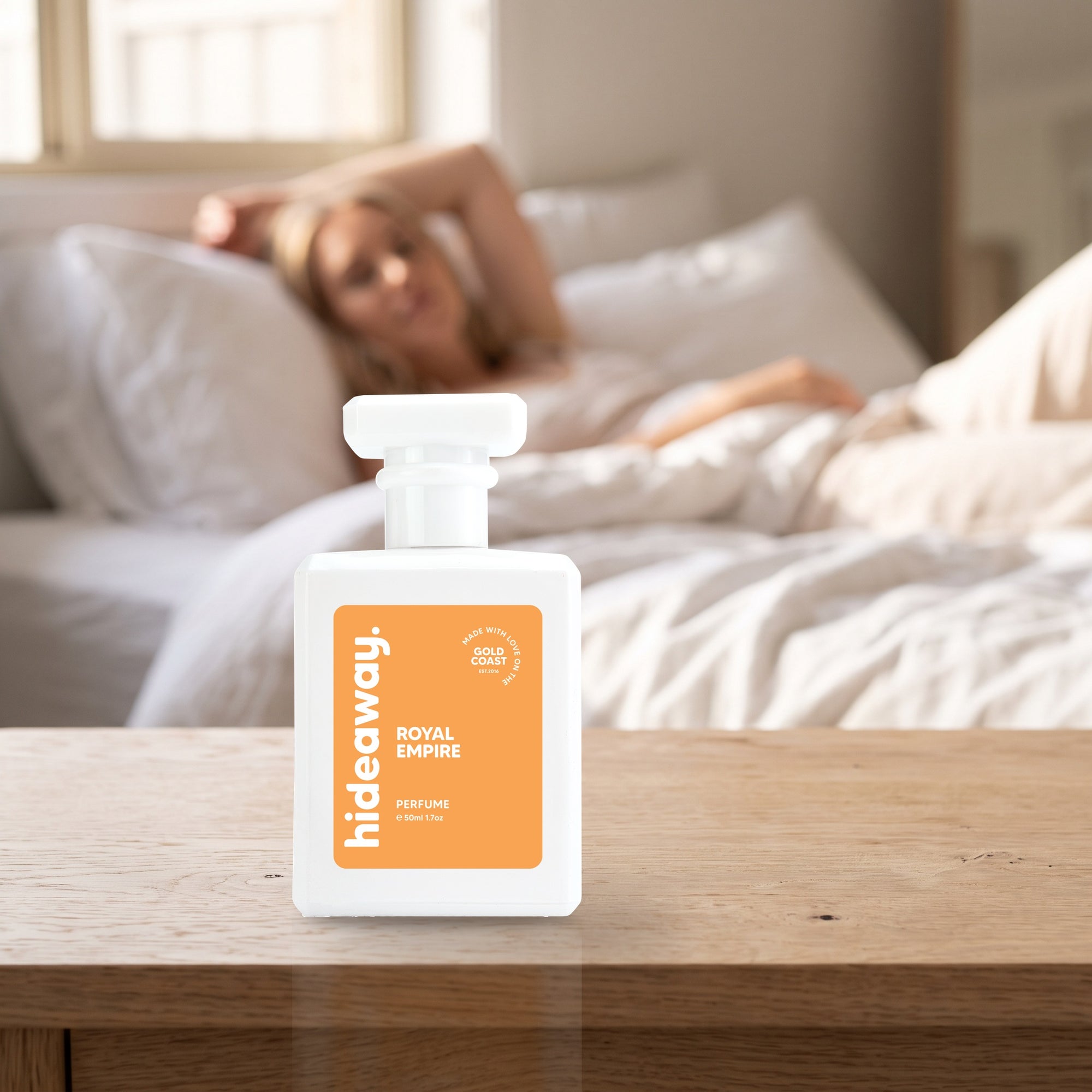 hideaway. Royal Empire perfume 50ml bottle on a bedside table in warm morning light