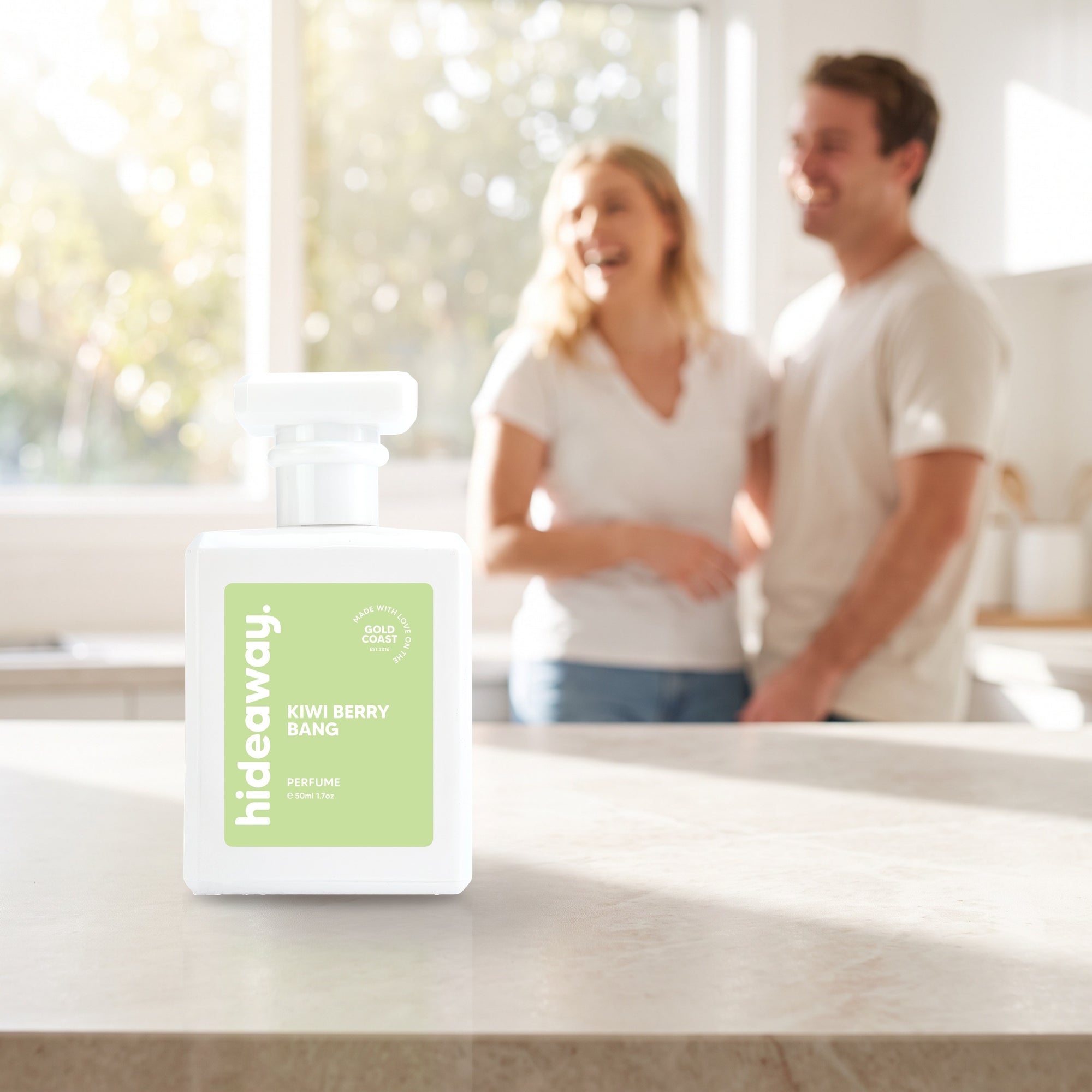 hideaway. Kiwi Berry Bang perfume 50ml bottle on a stone benchtop in a bright kitchen