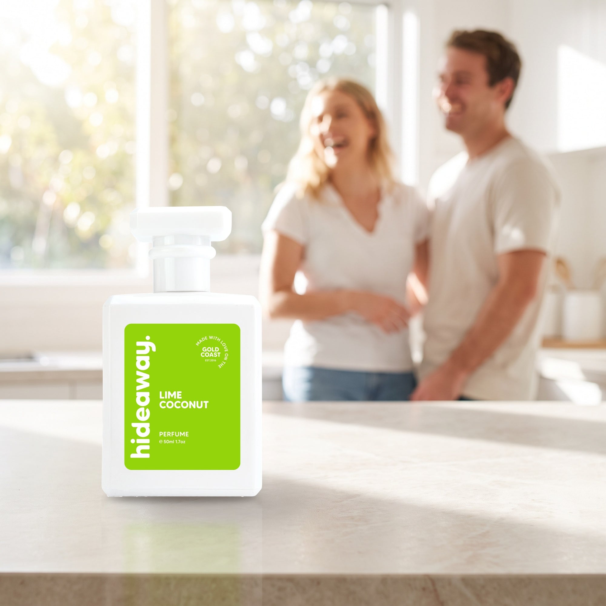 hideaway. Lime Coconut perfume 50ml bottle on a stone benchtop in a bright kitchen