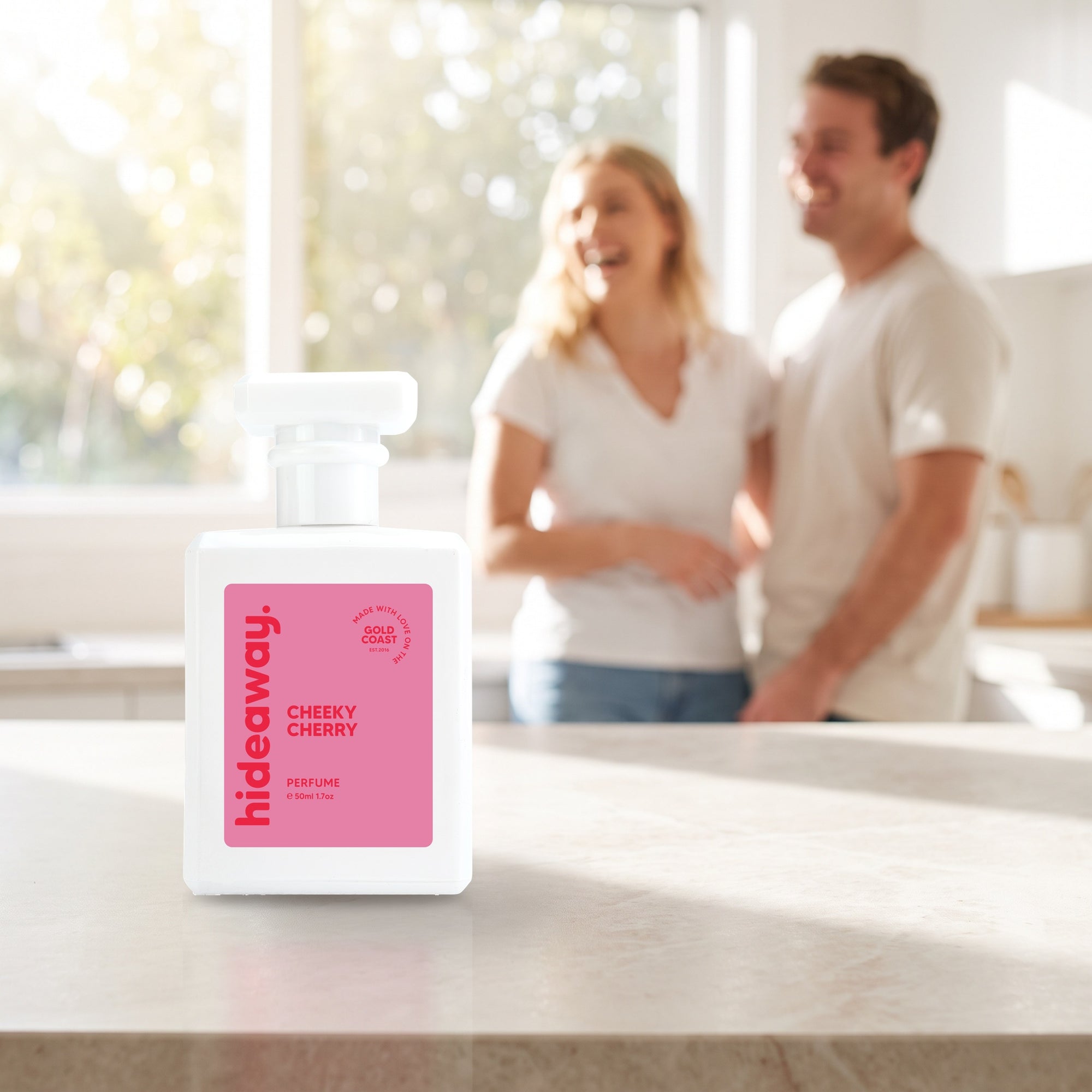 hideaway. Cheeky Cherry perfume 50ml bottle on a stone benchtop in a bright kitchen