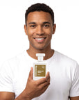 A smiling man holding Hideaway. Addictive Angel perfume