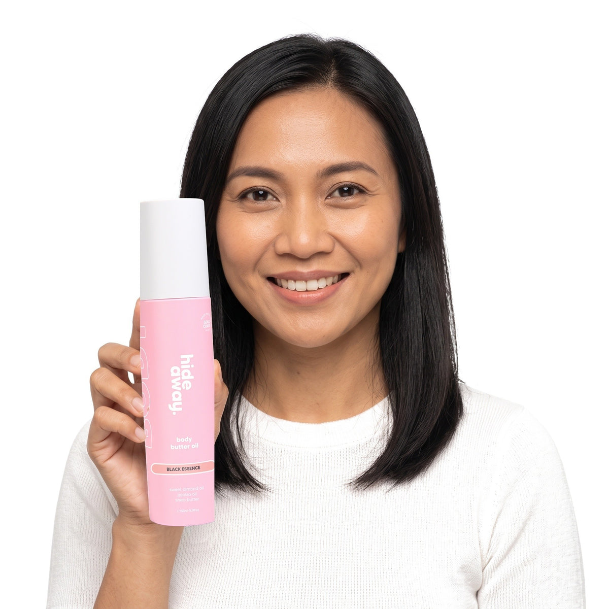 A smiling woman holding Hideaway. Black Essence body butter oil