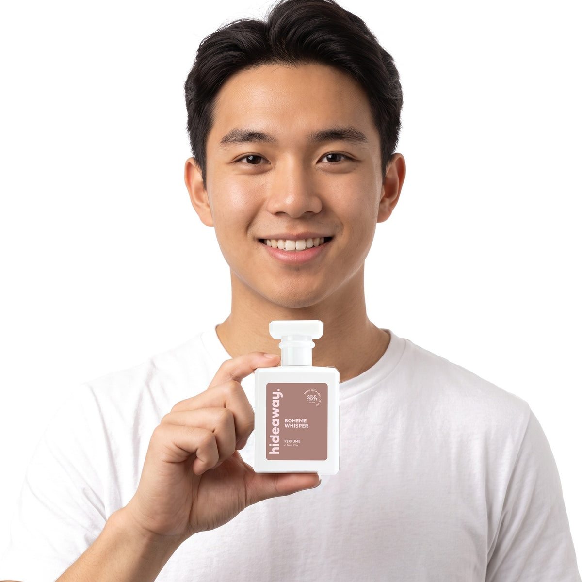 A smiling man holding Hideaway. Boheme Whisper perfume