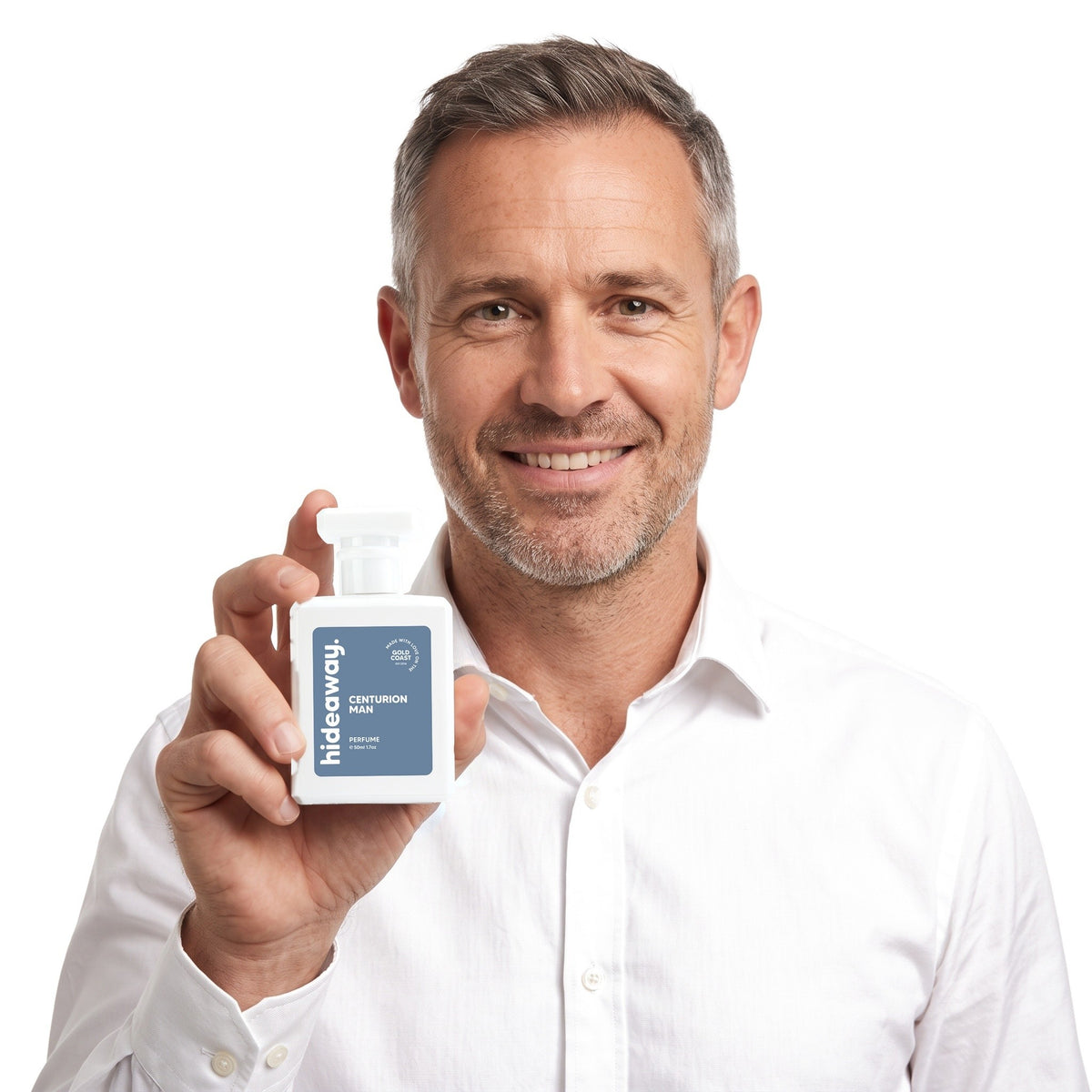 A smiling man holding Hideaway. Centurion Man perfume
