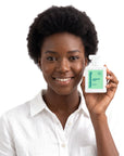 A smiling woman holding Hideaway. Forbidden Fruit perfume