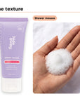 Shower mousse texture in an open palm, beside Hideaway. Aurora Rouge mini shower mousse