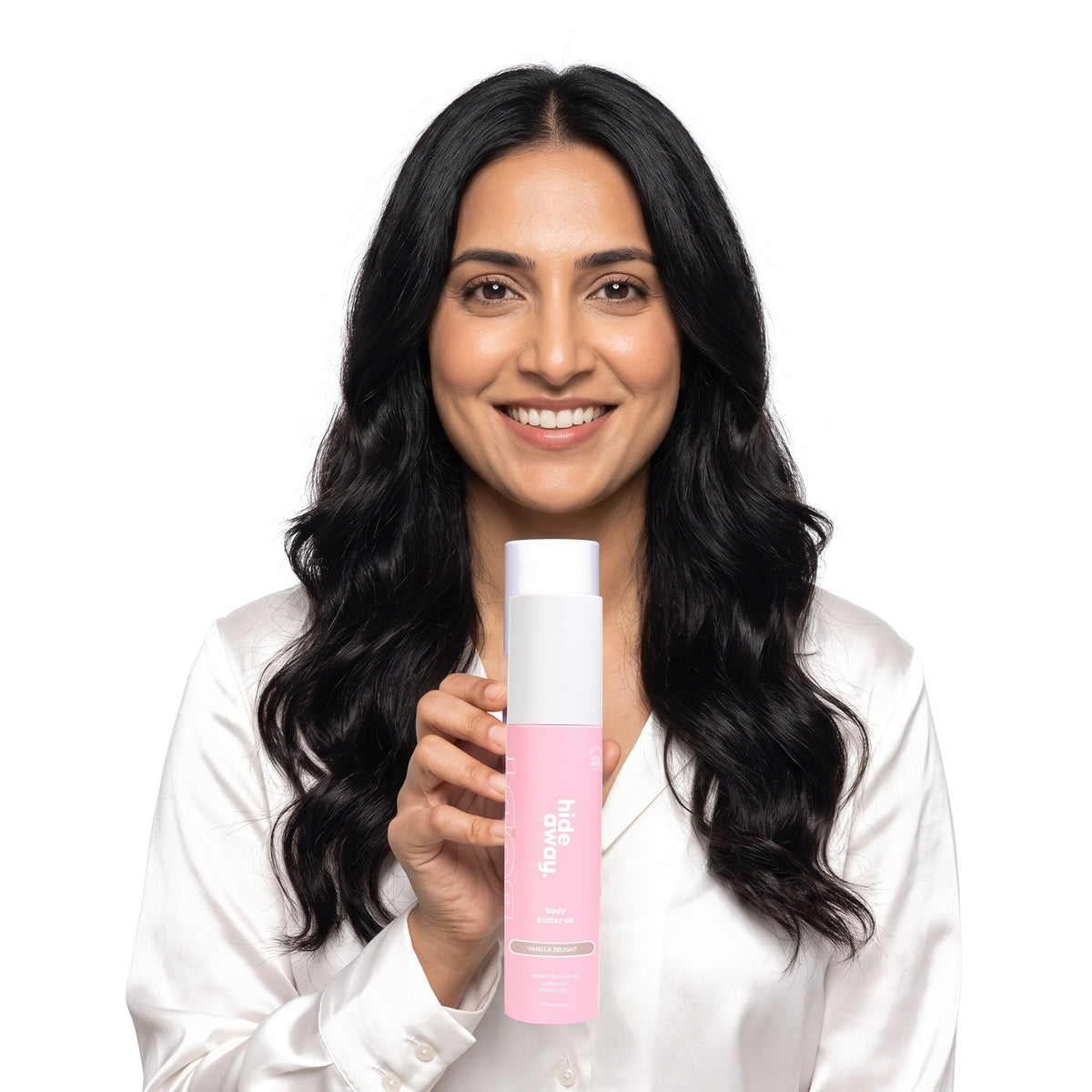 A smiling woman holding Hideaway. Vanilla Delight body butter oil